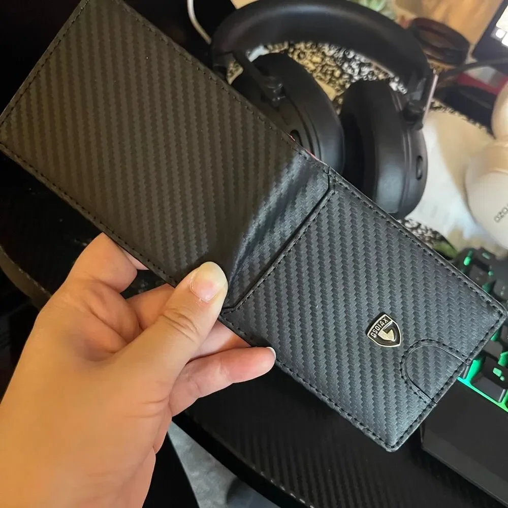 Men’s carbon fiber style wallet with bright red interior.
